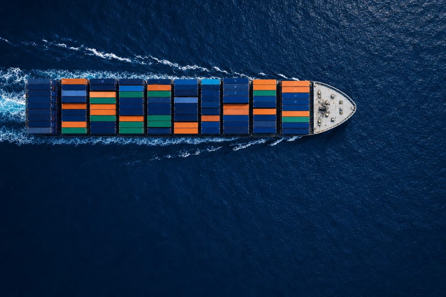 Container ship moving through deep ocean